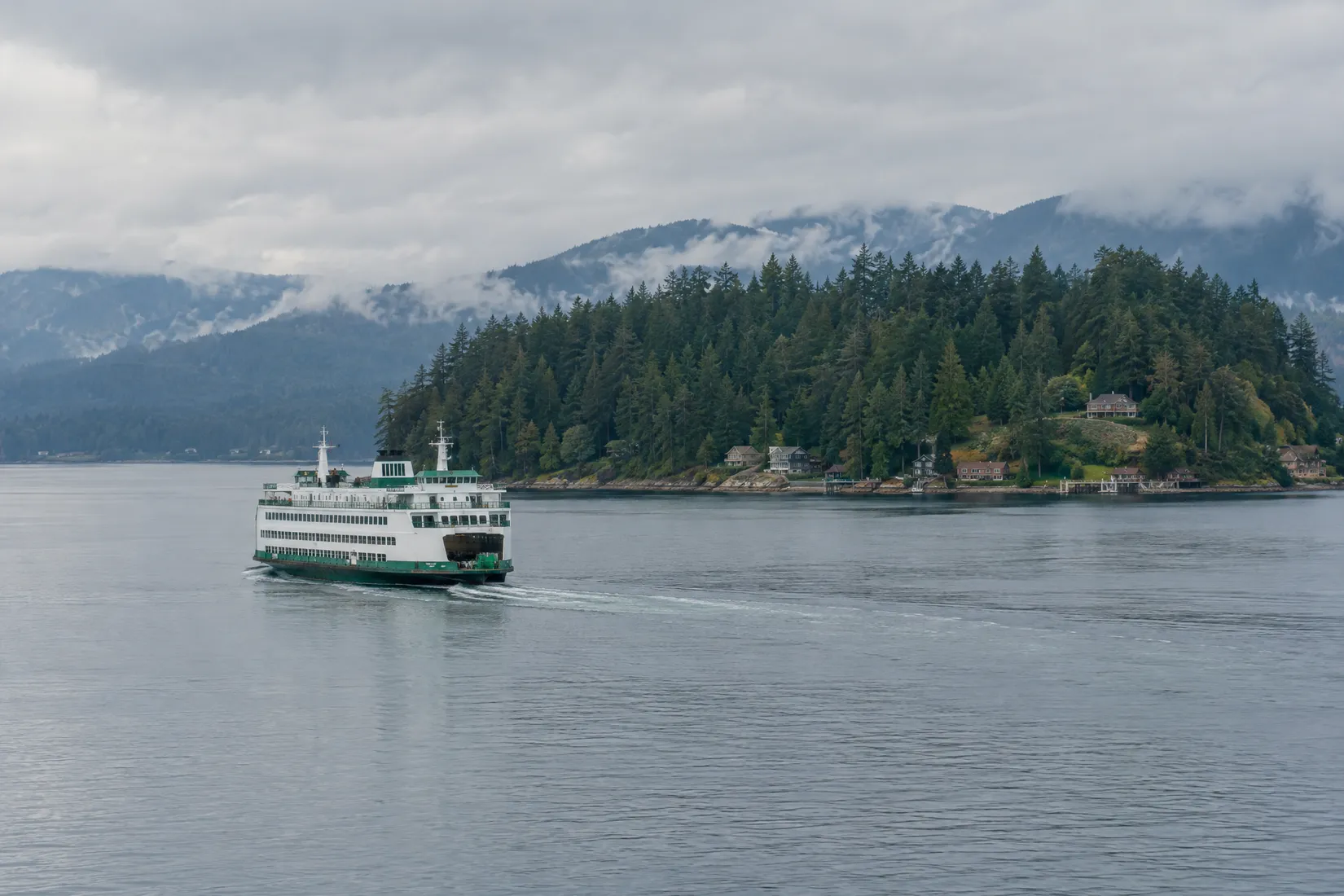Washington State ferry crossing Puget Sound with fir-covered islands behind