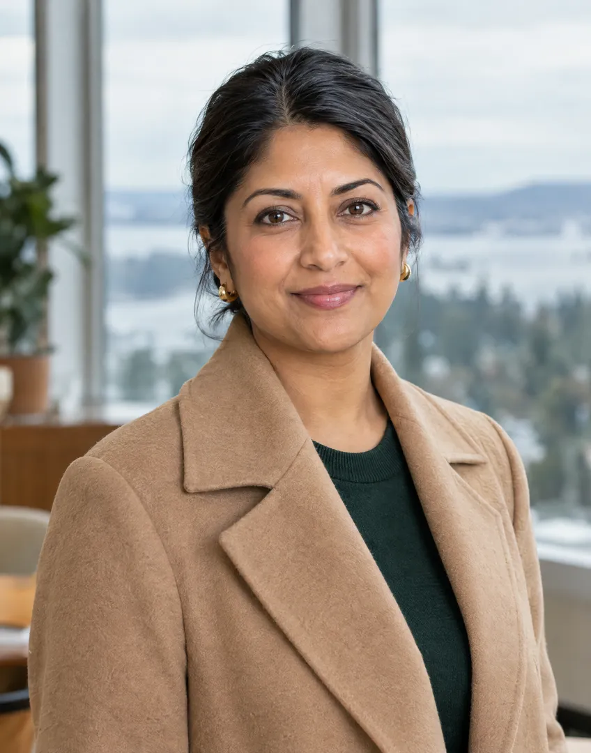 Priya Nair, Managing Broker for the Eastside at Renwick, a woman in her 40s with dark hair pulled back and a camel coat